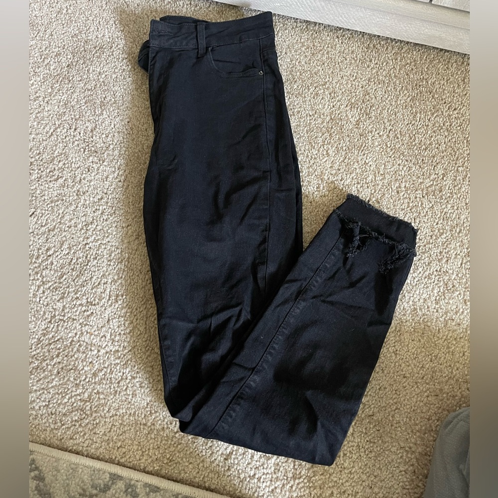Black skinny jeans with frayed ankles